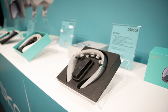 WARSAW, POLAND - FEBRUARY 18, 2026: An editorial view of SKG brand wellness products on display at a trade show, featuring the G7 Pro neck massager