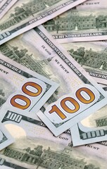 Obraz premium US dollar money bills pile on table. United States banknotes of USD currency close up.