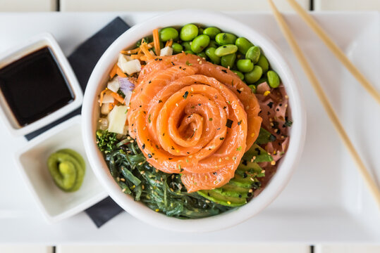A smoked salmon poke bowl with mixed raw vegetables