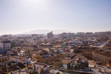 Fototapeta premium High angle urban skyline of Malaga city center with mountains on the horizon