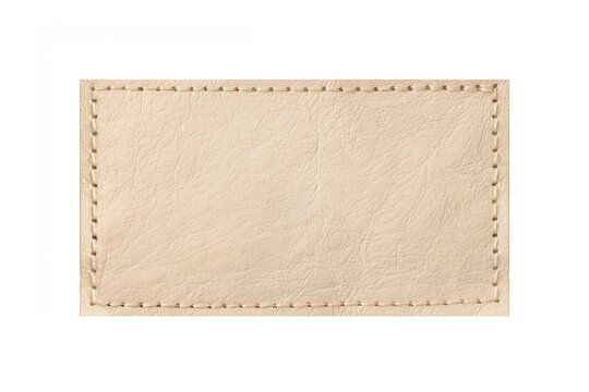 Beige leather patch with stitching isolated. Rectangular label texture detail. Blank stitched badge on light background. Natural leather surface closeup. Template for branding and craft design.