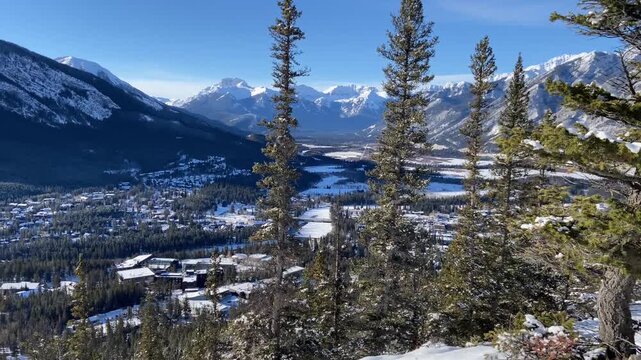 Canadian Rockies tracking video overlooking the town of Banff Canada and the Bow valley during winter from Tunnel Mountain.
