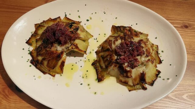 Roasted Artichokes with Serrano Ham and Marcona Almonds. Delicious perfect snack. High quality 4k footage