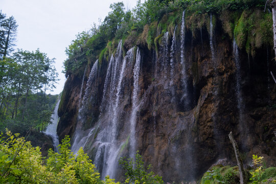 A large and refreshing waterfall in the middle of a green forest