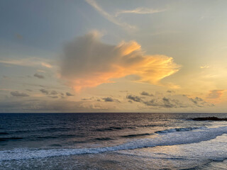 Obraz premium Dramatic Sunset Over Open Ocean, Fiery Cloud Formation Glowing Above Steady Waves, Wide Horizon Line, Warm Orange And Pink Tones, Tranquil Water