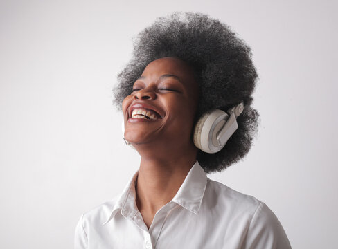 laughing woman listen music with headphone