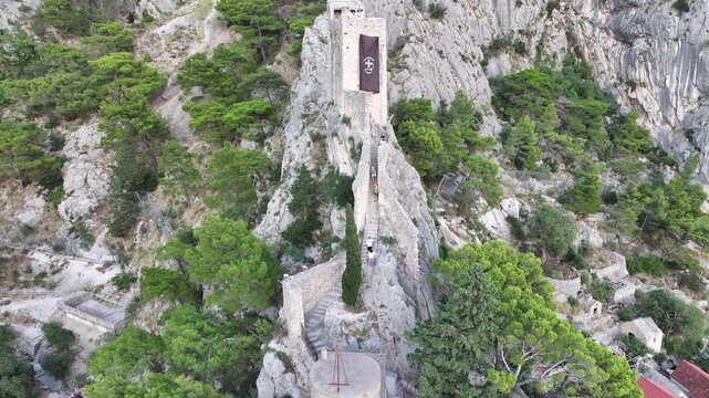Mirabela fortress illuminated during sunset over Omis old town, Croatia.