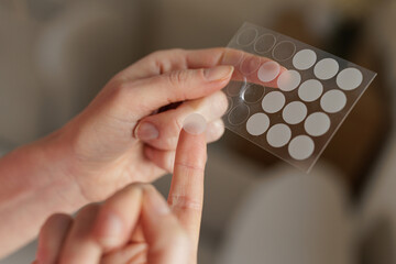 Applying Hydrocolloid Acne Patch From Sheet Skincare Treatment Closeup