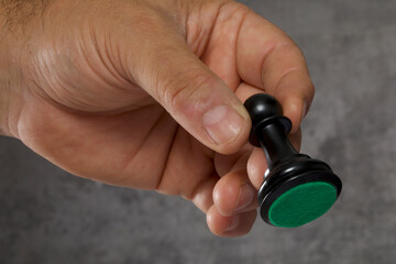 close - up of a man 's hand holding chess