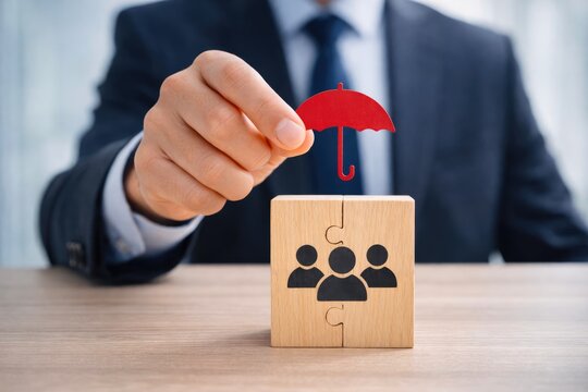 Businessman holding red umbrella protecting team concept of insurance and leadership