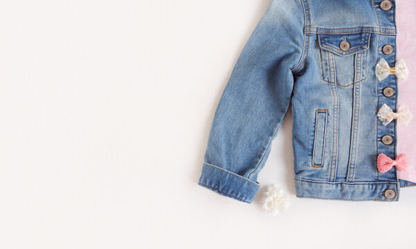 Ponk shirt with denim jacket and hair accessories. Set of kids clothes for spring or summer. Top view with copy space
