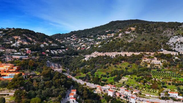 Picturesque mountain slopes with numerous gorgeous villas. Rocky city landscape of Nice, France from drone.