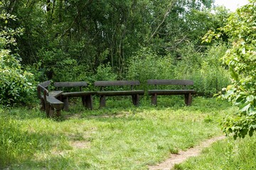 Nooks with benches made of logs and a path.