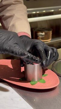 Professional chef shaping traditional Kibbeh Nayyeh in a luxury restaurant, Middle Eastern gourmet food preparation.