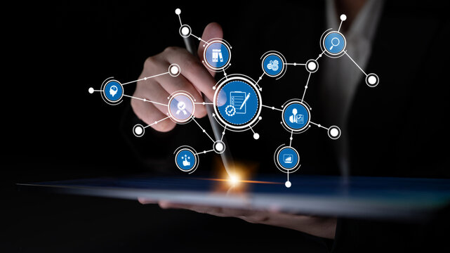 A hand holding a tablet displaying visual icons representing digital transformation in business, emphasizing online shopping, technology connectivity, and innovation insights. Tessel