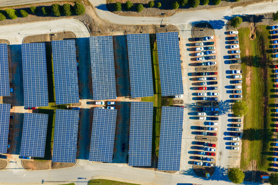 Photovoltaic solar panels over car parking lot in Clemson, South Carolina for generation of renewable energy. Sustainable power production integrated in urban infrastructure.