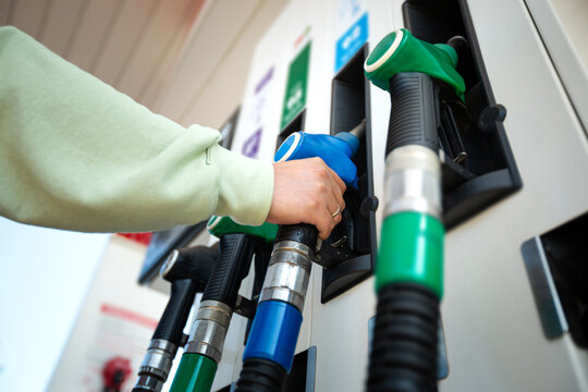 Man holding pump ready to refuel car with gasoline