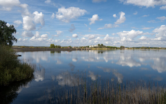 Wide view of Proserpina Reservoir with cloud reflections, Spain