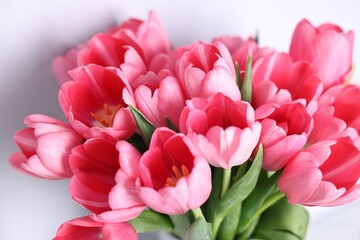 Fototapeta premium Bouquet of pink tulips on blurred grey background, closeup