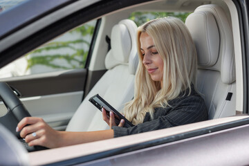 Woman reckless driving a car while looking at a smartphone and texting. © 24K-Production