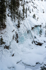 Icy Winter Wonderland: Snow-Covered Cliffs and Frozen Waterfalls Capture Nature's Winter Majesty. Johnston Canyon, Banff, Canada