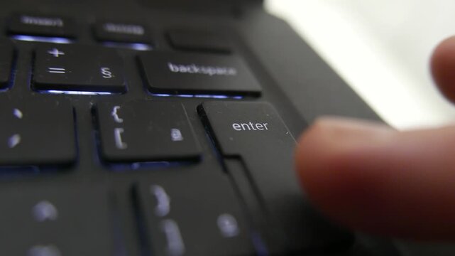 POV of someone pressing the Enter Key non-stop. A person typing the Enter Key. Typing on a laptop keyboard, close-up shot. A computer keyboard