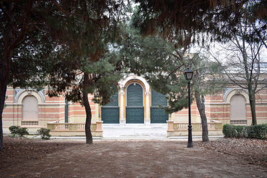 Historic Pavilion in Parque del Retiro Framed by Trees in Madrid, Spain