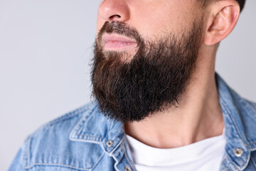 Fototapeta premium Man with mustache and beard on light grey background, closeup