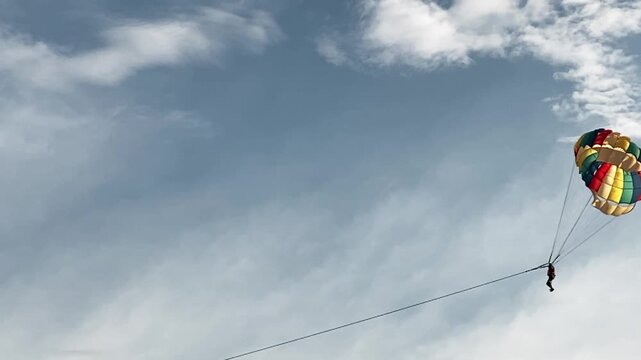 Parasailing over the ocean, slow motion view
