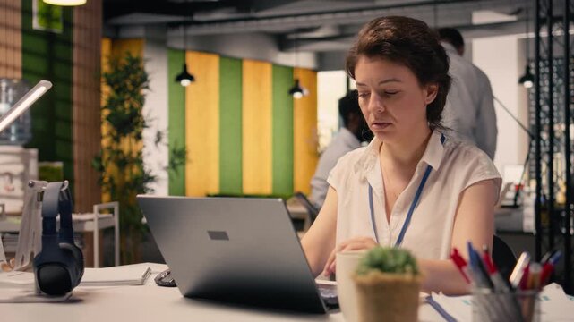 Frowning businesswoman with confused and skeptical expression at desk, appearing uncertain and indecisive reviewing visual data on laptop. Undetermined irregular performance metrics, confusion.