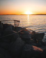 Fishing Nets on Rocky Shore at Sunset by Lake Balaton