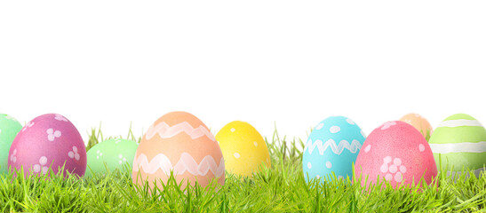 Fototapeta premium Easter eggs in green grass against white background