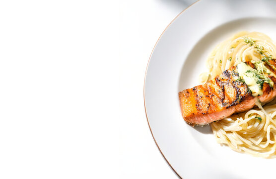 Grilled Salmon with Pasta on White Plate Isolated with Copy Space