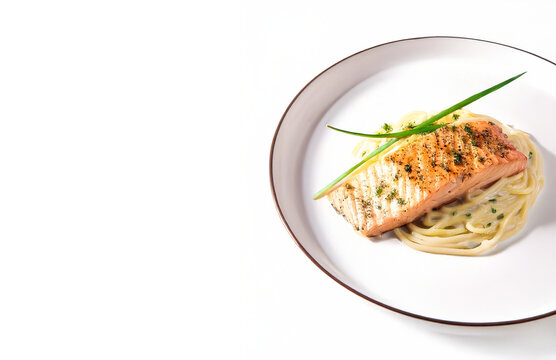 Grilled Salmon with Pasta on White Plate Isolated with Copy Space