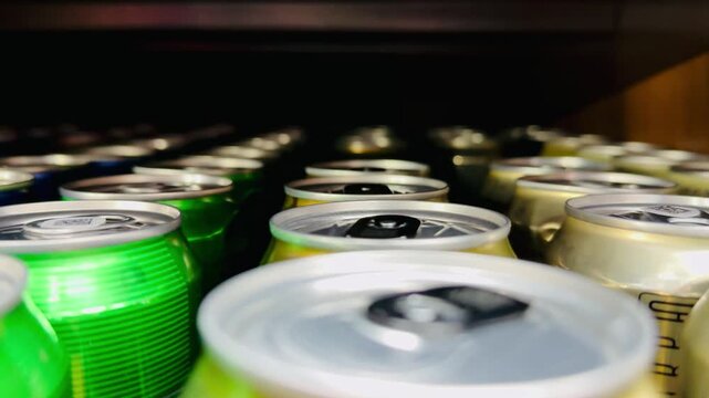 Close Up Yellow Beer Cans Shelf Tight Macro Composition Showing Lined Aluminum Cans With Vibrant Labels And Moisture Droplets, Pull Tabs In Focus, Blurred Background Of Stocked Supermarket.