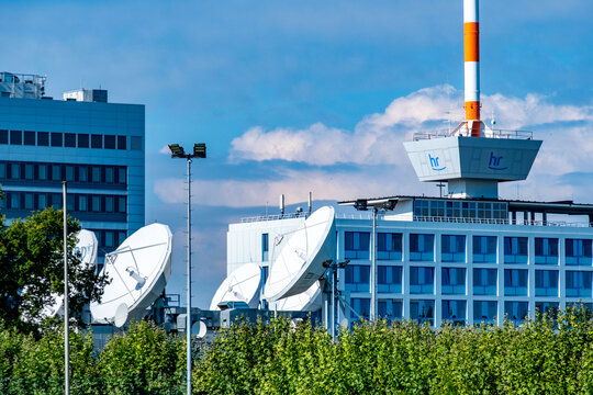 Modern building facade featuring prominent hr logo, media ARD 1 emblem, set against blue sky, European public broadcaster, German telecommunications, headquarters Hessischer Rundfunk, Frankfurt