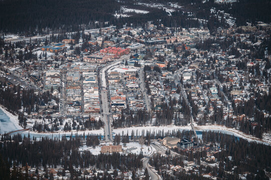 Aerial view of snow-covered streets and buildings in a mountain town (Banff) during winter