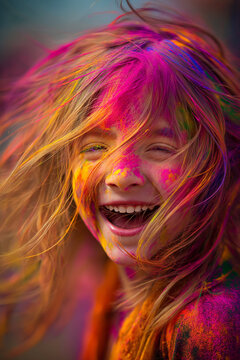 Happy girl celebrating Holi festival with colorful powder, joyful child laughing during traditional Indian celebration of colors