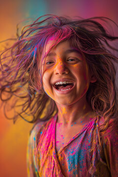 Happy girl celebrating Holi festival with colorful powder, joyful child laughing during traditional Indian celebration of colors