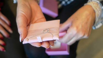 Joyful moment of unwrapping Christmas gifts with loved ones around the tree