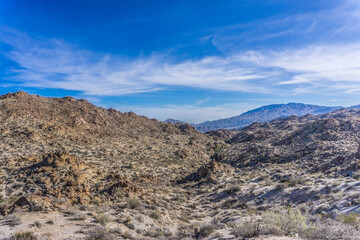 A rocky desert landscape with a clear blue sky