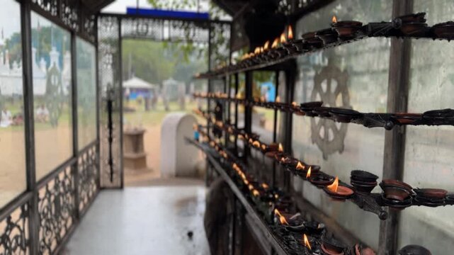 Burning oil lamps in Buddhist temple, Sri Lanka