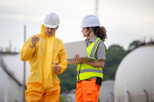 Specialized technical team performing chemical analysis and ecological monitoring near a petrochemical plant to ensure environmental compliance, Environmental scientist inspecting a water sample