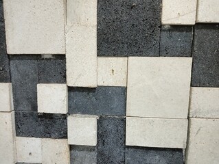 Abstract background of square and rectangular stone or tile samples in various shades of grey,...