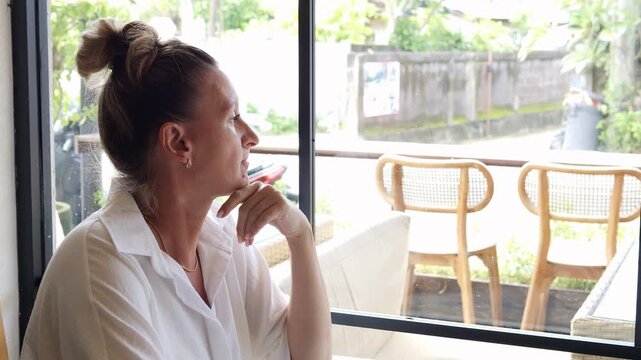 Urban solitude moment in busy city cafe woman reflecting by window in calm atmosphere Solitude becomes mindful pause solitude supports emotional balance solitude defines peaceful urban lifestyle