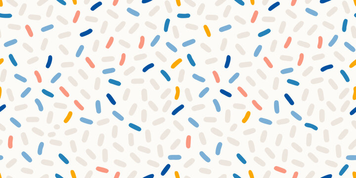 Colorful confetti sprinkles scattered across a light background pattern