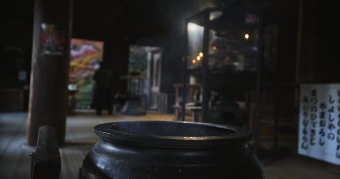 Steam rising from black cauldron in ancient Japanese castle