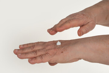 Wrinkles on aged hands show wrinkles. Aged skin with cream. Aged skin care. Aged skincare texture. Senior woman hands with cream. Senior hand skin cream.