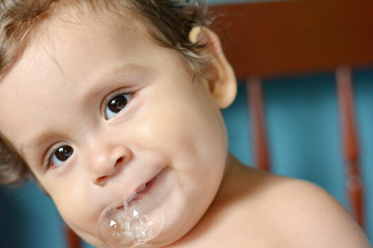 Latin toddler with saliva bubbles.
