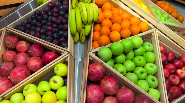 Fresh fruit display with apples bananas oranges and kiwi in supermarket